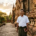 Person walking near historic architecture in Mandalay