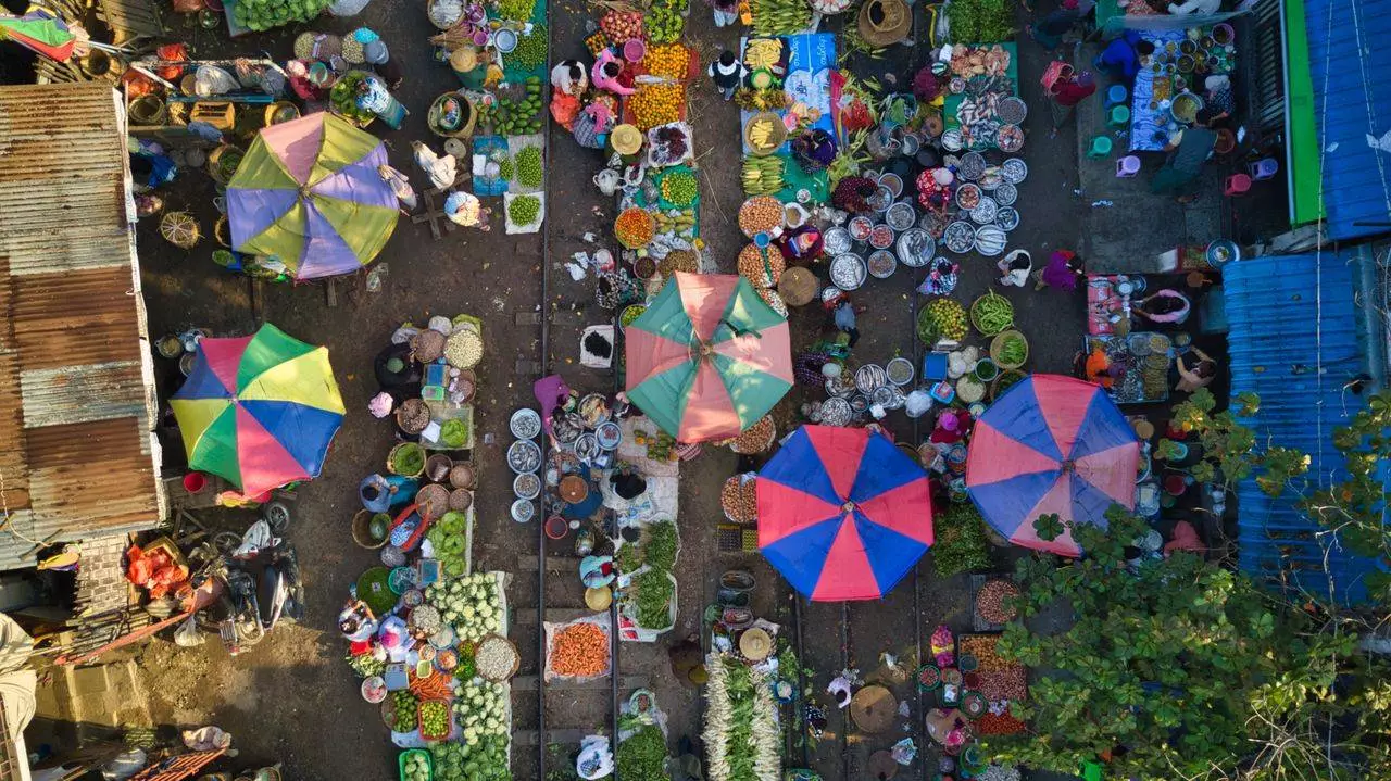 Aerial view of Mandalay's bustling street market representing the cultural connection between temples and daily market life