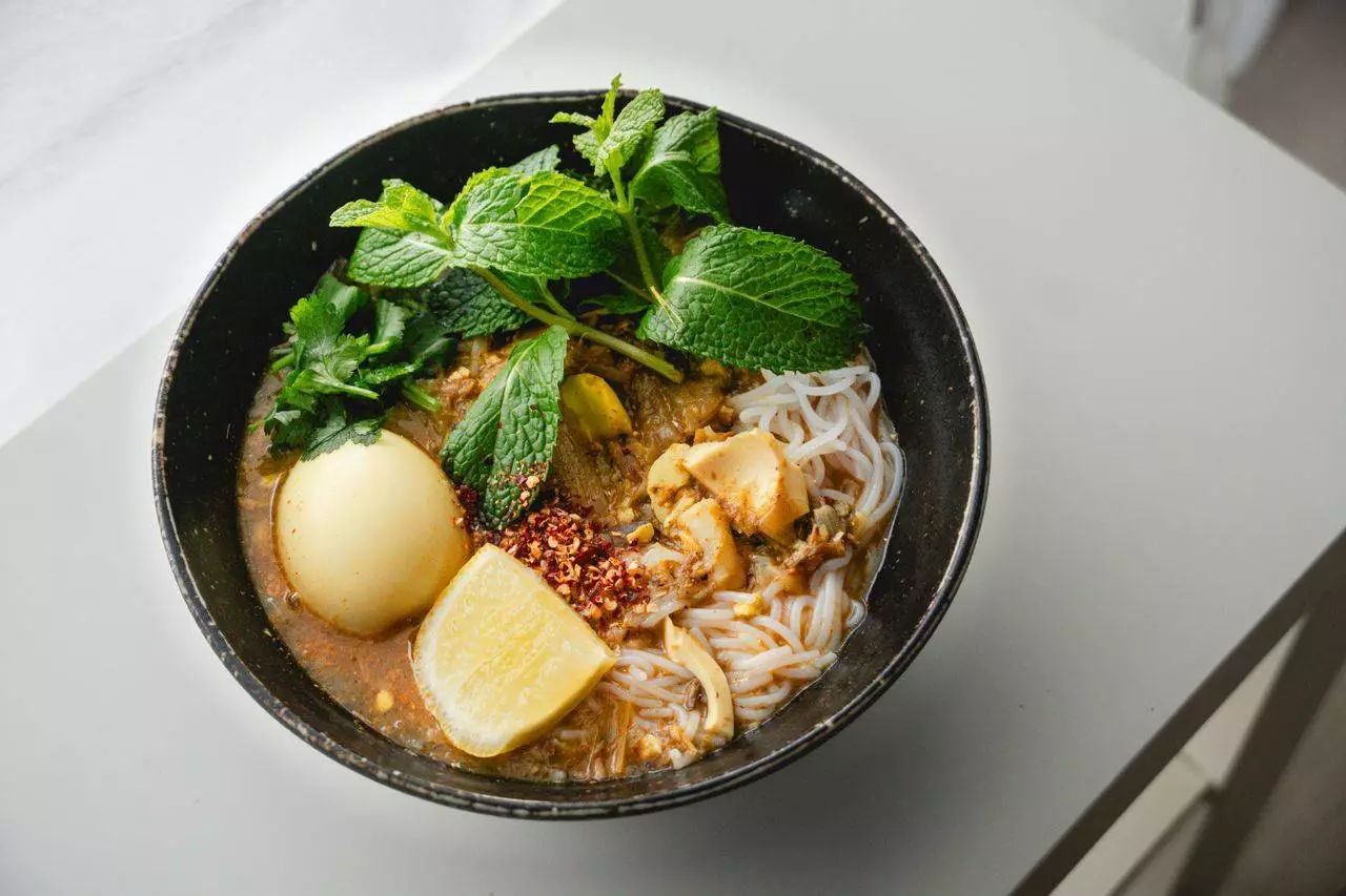 Authentic Burmese Mee Shay noodle soup representing the best traditional Mandalay Htoe Mont and dessert culture in 2026