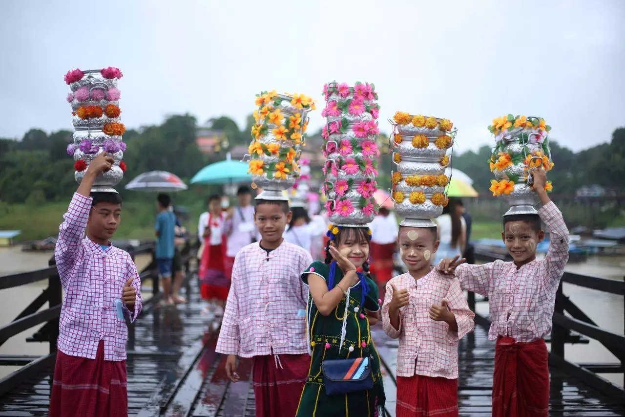 Children in vibrant traditional festival attire representing Myanmar's cultural dress traditions and Htamein fashion heritage